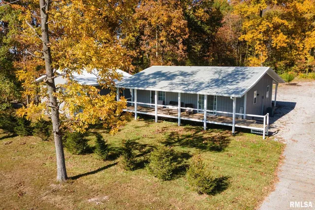 a view of a house with backyard porch and sitting area