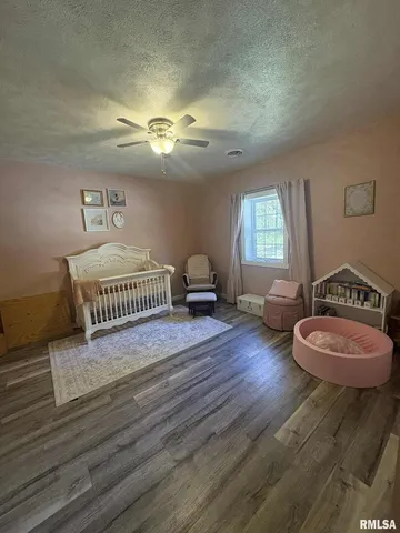 a bedroom with a bed and a chair