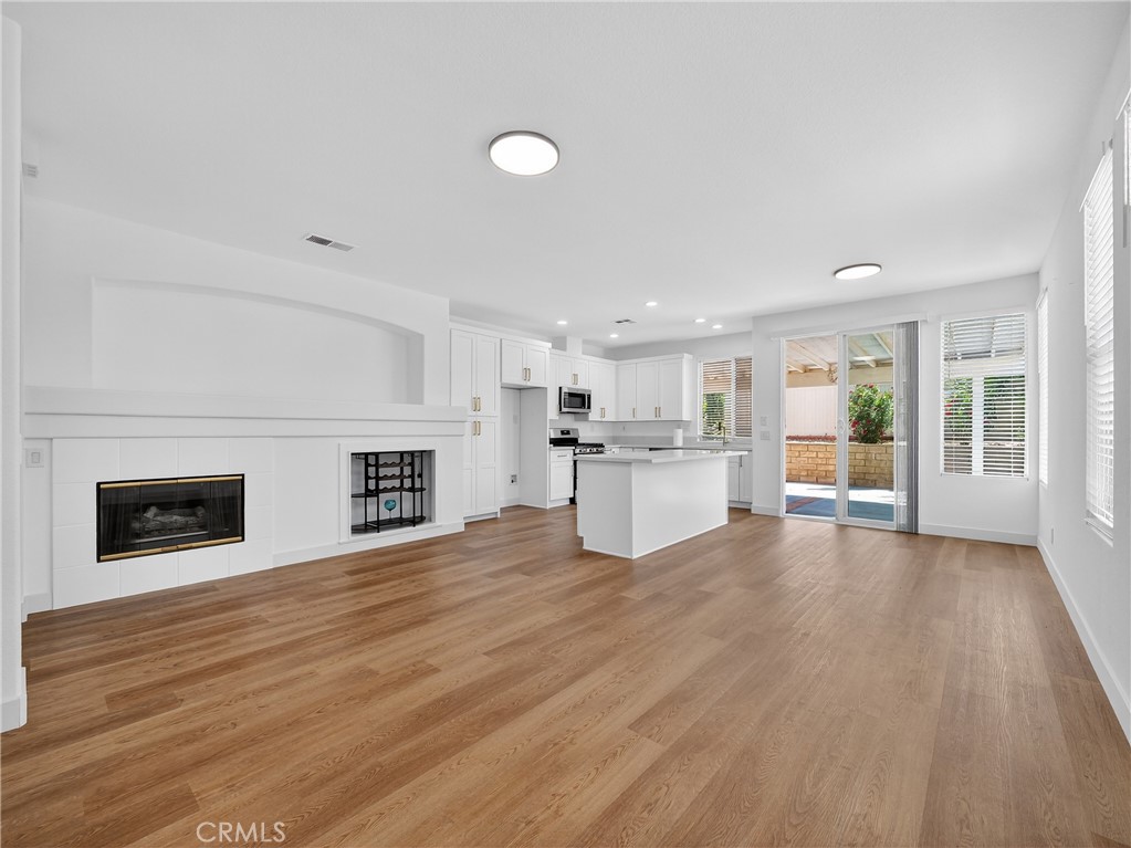 1436 Riviera Avenue Banning, CA 92220 - Photo 8 of 43 a view of a livingroom with wooden floor and kitchen