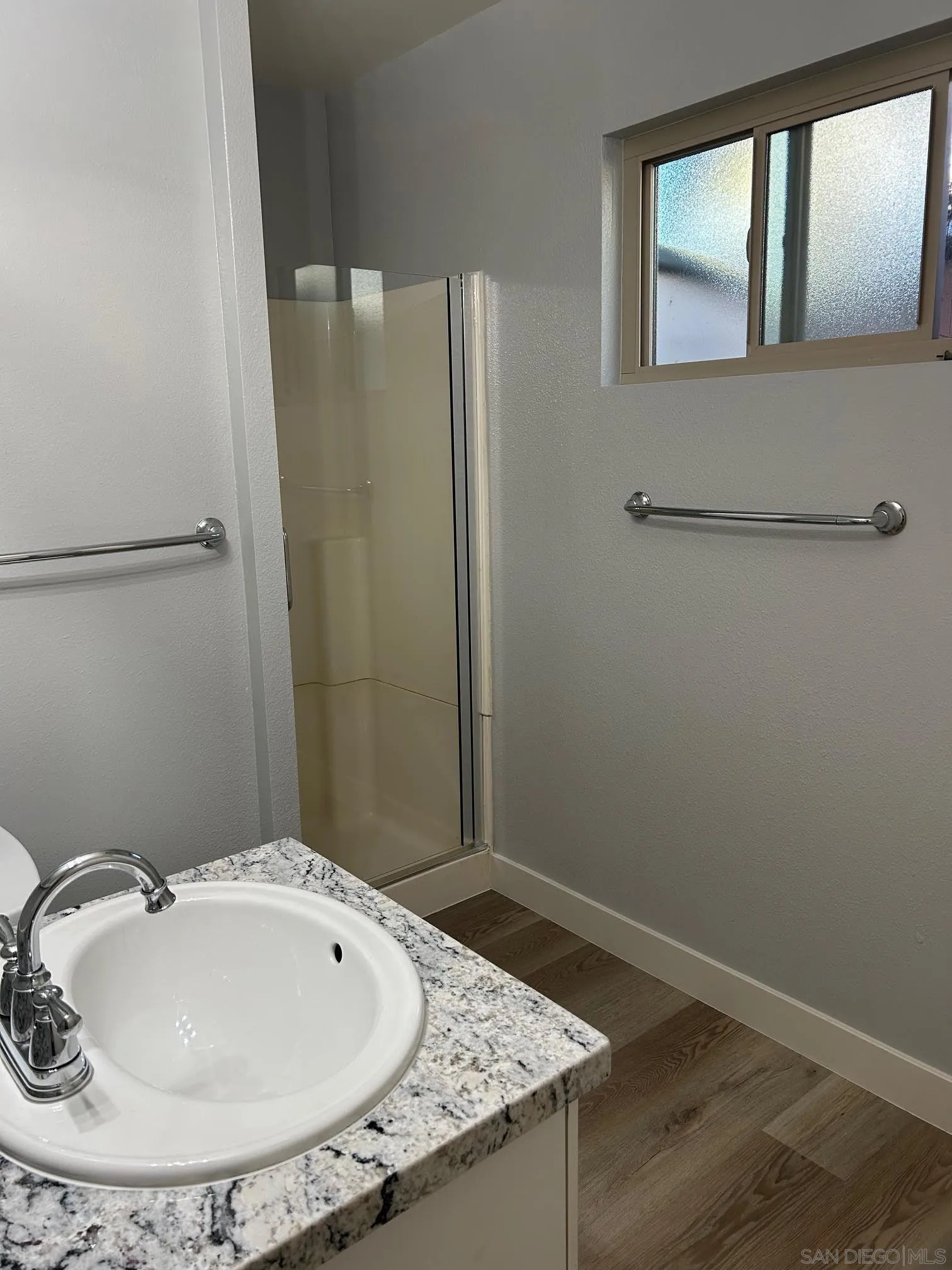 225 Melrose Avenue, Unit 2 Encinitas, CA 92024 - Photo 12 of 18 a bathroom with a sink and a mirror