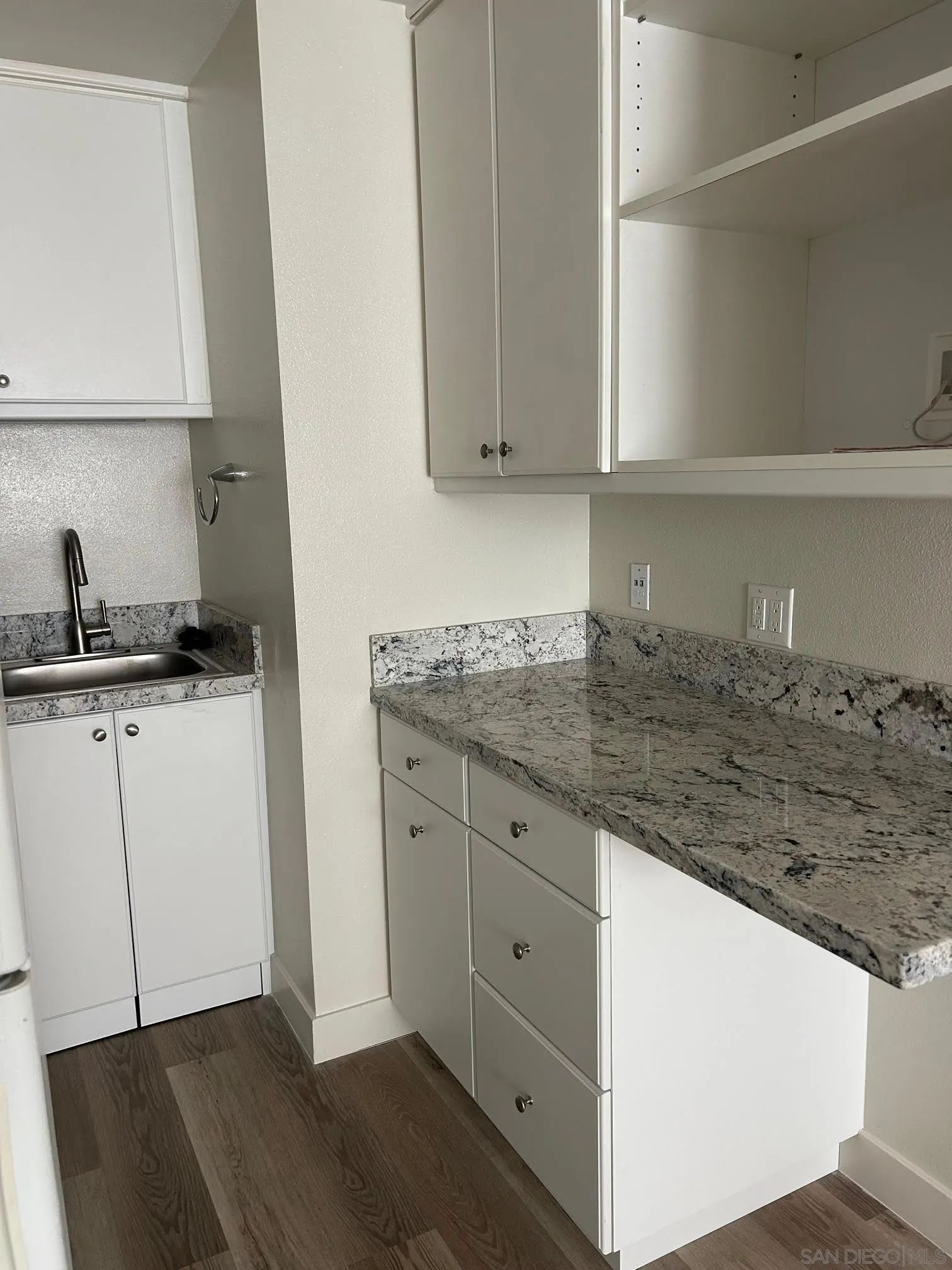 225 Melrose Avenue, Unit 2 Encinitas, CA 92024 - Photo 10 of 18 a kitchen with granite countertop white cabinets and a stove