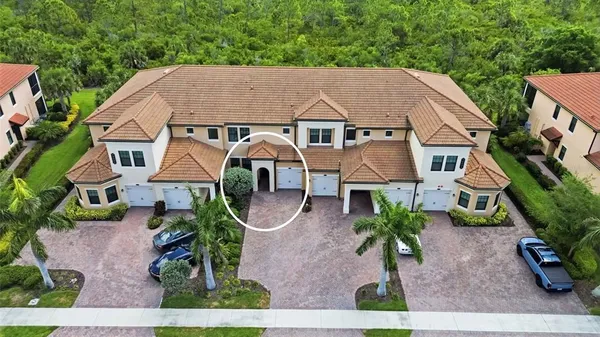 an aerial view of a house with yard and sitting area