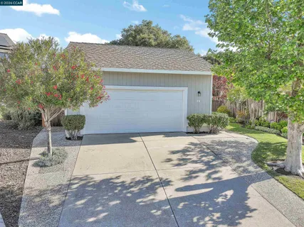 a front view of a house with a yard and a garage
