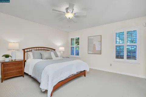 a spacious bedroom with a bed and a chandelier