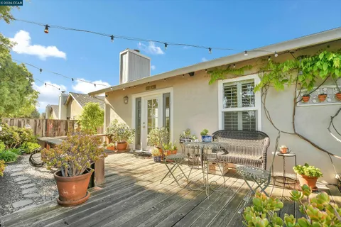 a view of a patio with couches table and chairs and potted plants