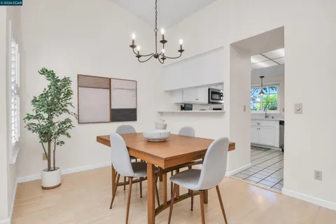 a view of a dining room with furniture and chandelier