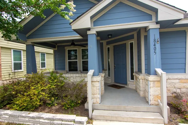 front view of a house with potted plants