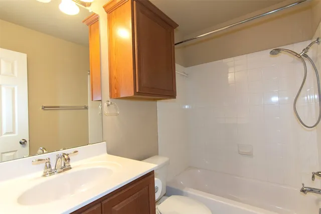 a bathroom with a double vanity sink mirror and shower