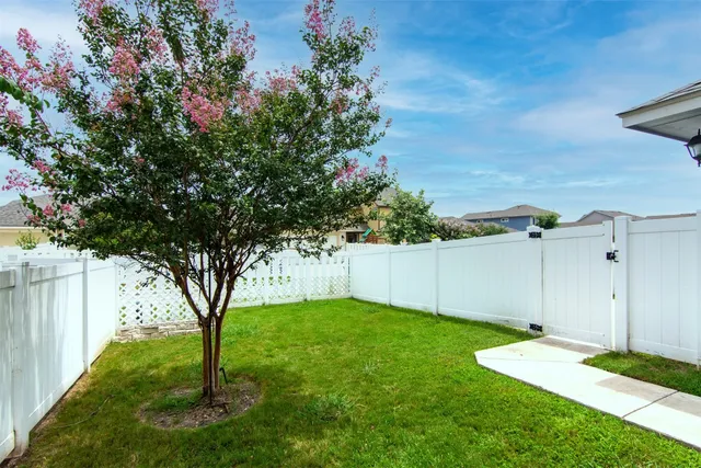 a view of residential houses with yard and entertaining space
