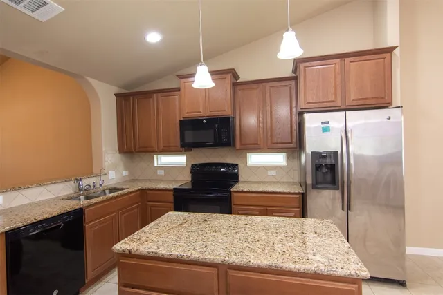 a view of a storage and utility room with granite countertop cabinets