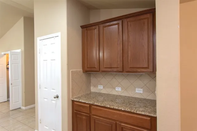 an empty room with windows and chandelier