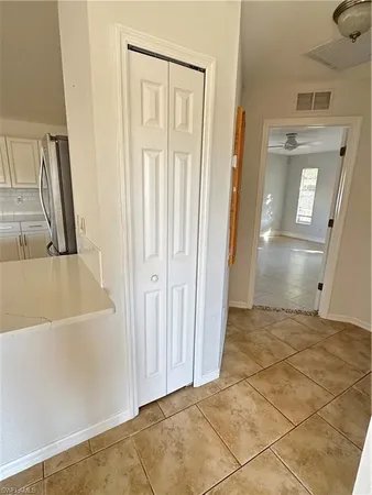 a view of a livingroom with wooden floor and a bathroom