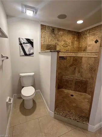 a bathroom with a toilet and a shower