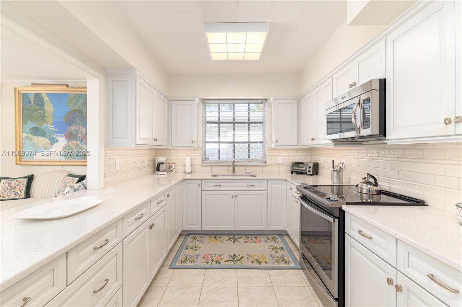 18 Gomez Road Jupiter Island, FL 33455 - Photo 11 of 34 a kitchen with sink cabinets and window