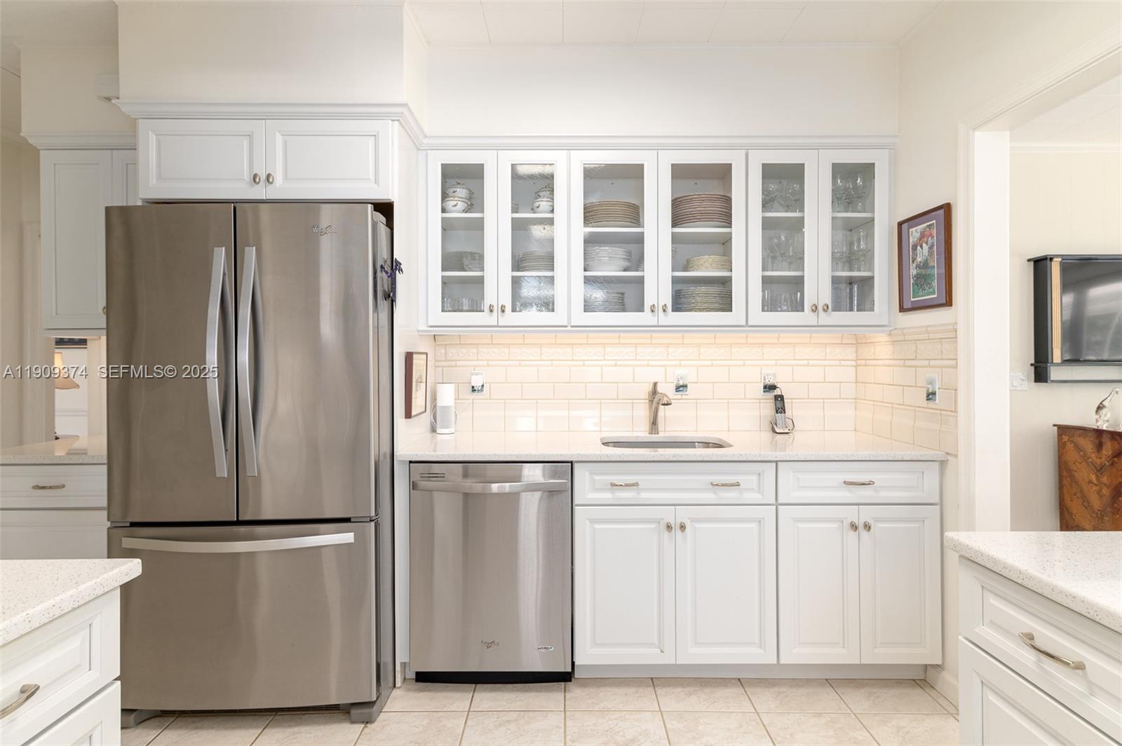 18 Gomez Road Jupiter Island, FL 33455 - Photo 12 of 34 a kitchen with stainless steel appliances a refrigerator and cabinets