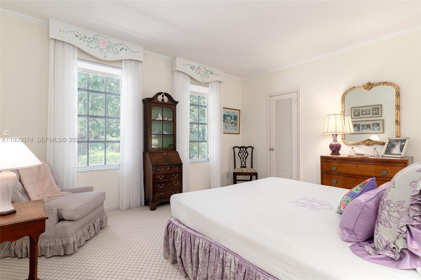 18 Gomez Road Jupiter Island, FL 33455 - Photo 19 of 34 a bedroom with a bed and dresser with mirror