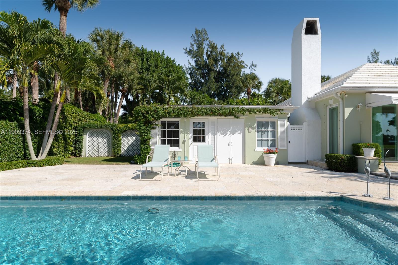 18 Gomez Road Jupiter Island, FL 33455 - Photo 21 of 34 a view of a patio with a table and chairs under an umbrella
