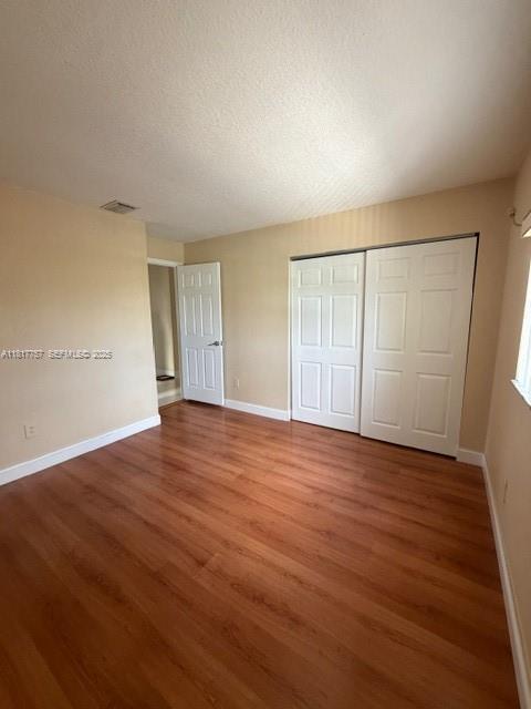 10290 Southwest 139th Court Miami, FL 33186 - Photo 38 of 66 an empty room with wooden floor and windows
