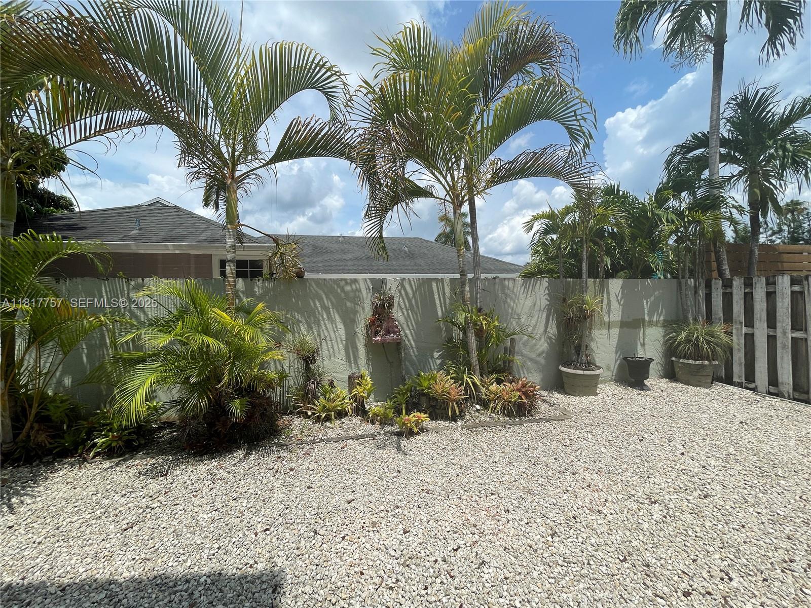 10290 Southwest 139th Court Miami, FL 33186 - Photo 48 of 66 a view of a backyard with plants and a patio