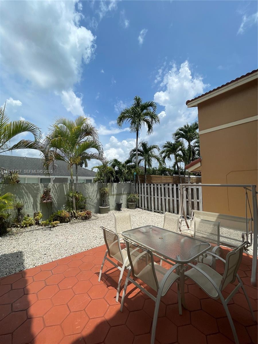 10290 Southwest 139th Court Miami, FL 33186 - Photo 51 of 66 a patio with table and chairs