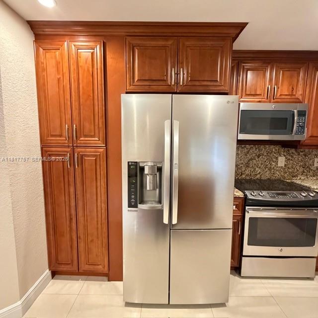 10290 Southwest 139th Court Miami, FL 33186 - Photo 6 of 66 a kitchen with stainless steel appliances granite countertop a refrigerator and a stove