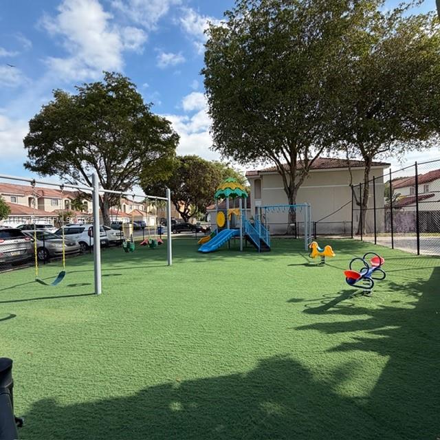 10290 Southwest 139th Court Miami, FL 33186 - Photo 66 of 66 a view of a park with swings and slides