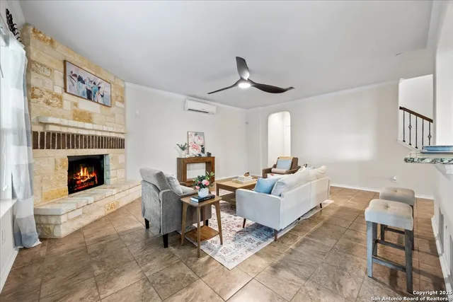 a living room with furniture and a fireplace