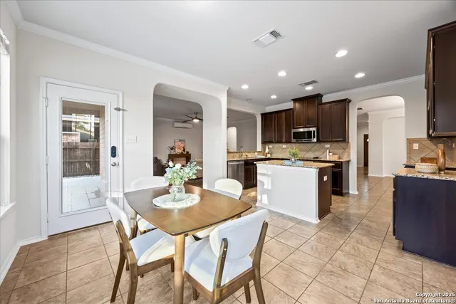 a kitchen with stainless steel appliances granite countertop a sink stove refrigerator and cabinets