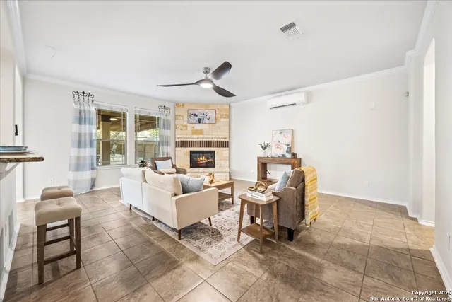 a living room with furniture a fireplace and a table