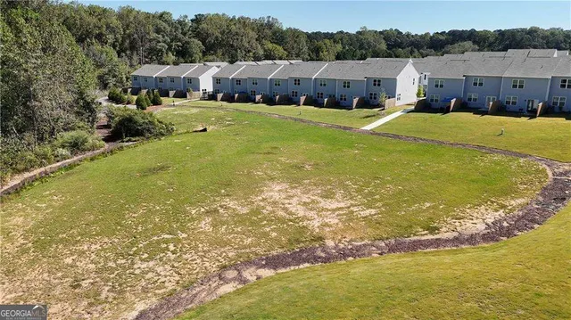 a swimming pool with outdoor seating and yard