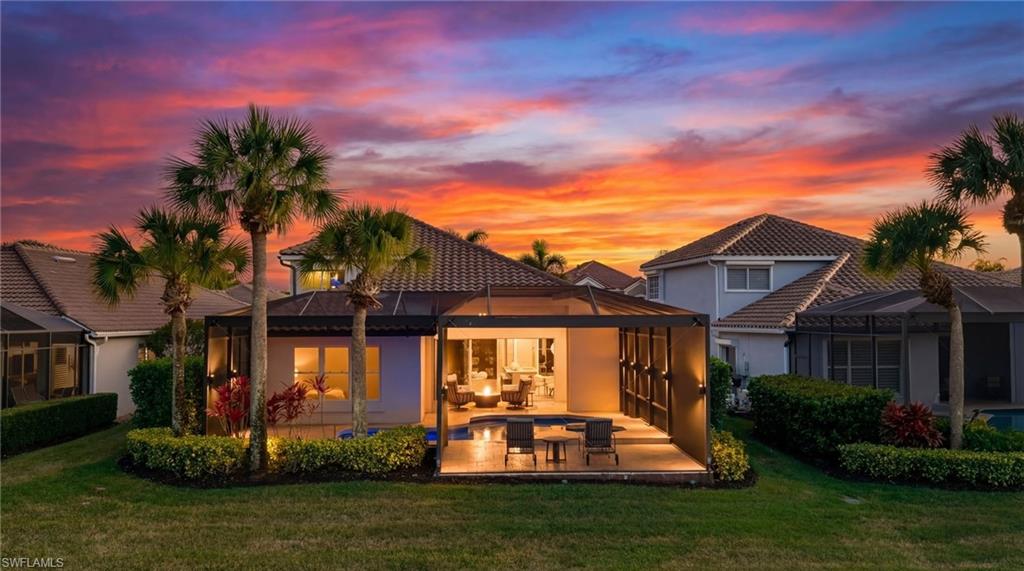 17959 Modena Road Miromar Lakes, FL 33913 - Photo 1 of 48 a front view of a house with a yard