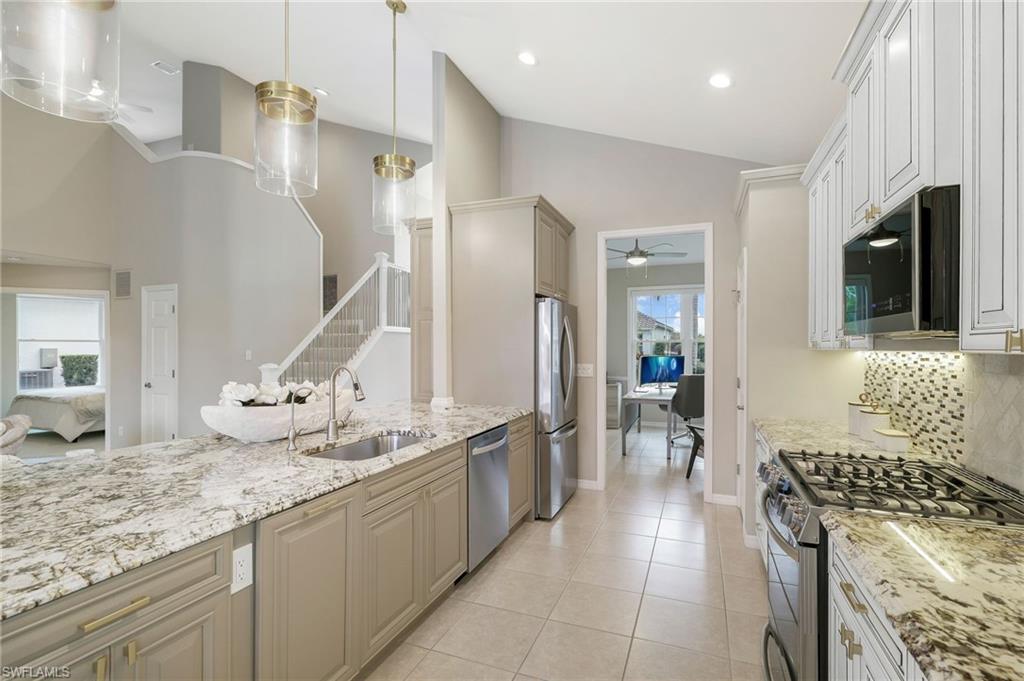 17959 Modena Road Miromar Lakes, FL 33913 - Photo 11 of 48 a kitchen with sink stove and refrigerator