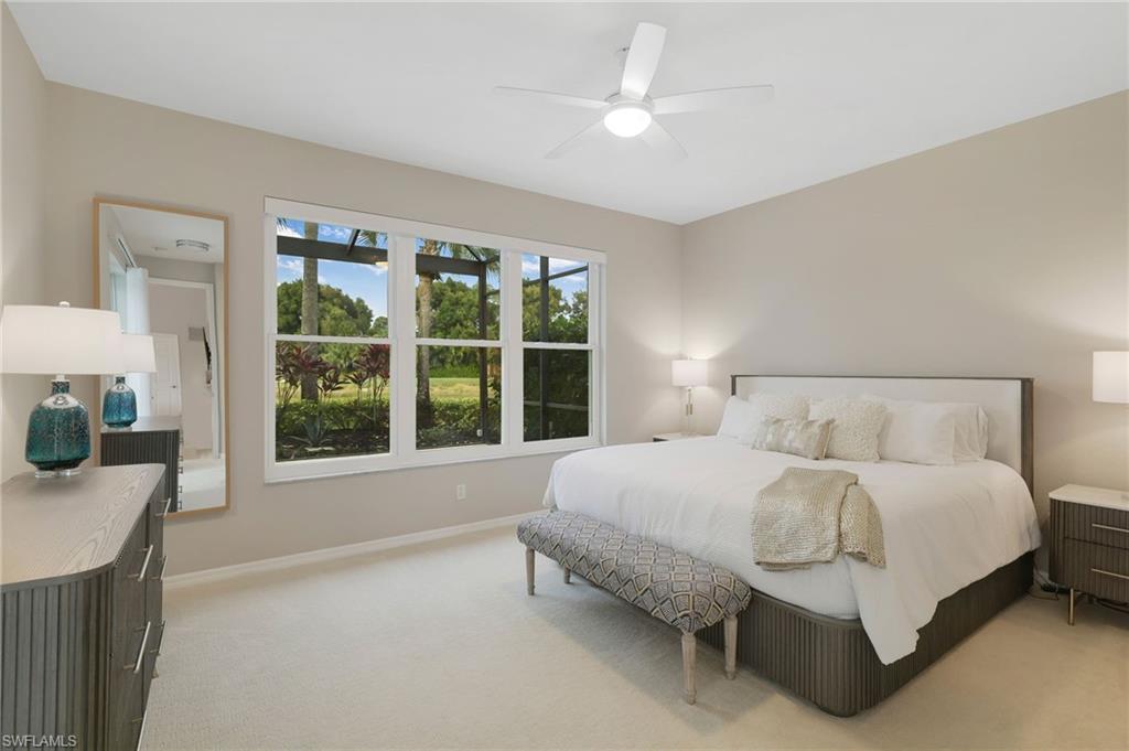 17959 Modena Road Miromar Lakes, FL 33913 - Photo 18 of 48 a bedroom with a bed couch and window