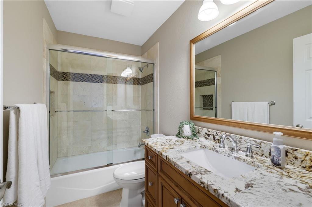 17959 Modena Road Miromar Lakes, FL 33913 - Photo 23 of 48 a bathroom with a granite countertop sink toilet and shower