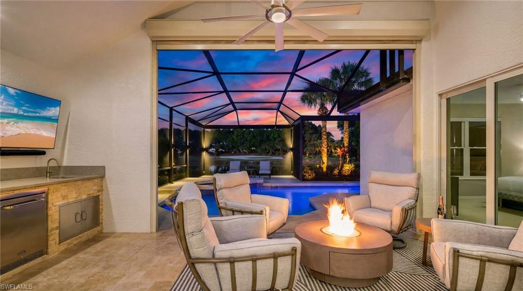 17959 Modena Road Miromar Lakes, FL 33913 - Photo 30 of 48 a room with furniture and a fireplace