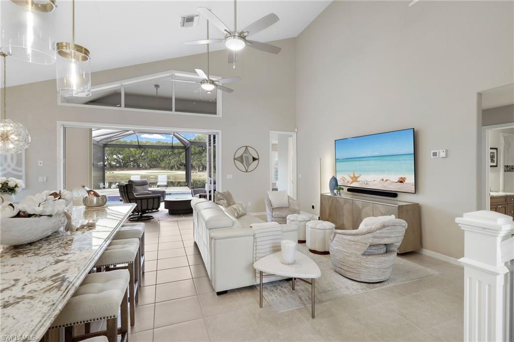 17959 Modena Road Miromar Lakes, FL 33913 - Photo 3 of 48 a living room with furniture and a flat screen tv