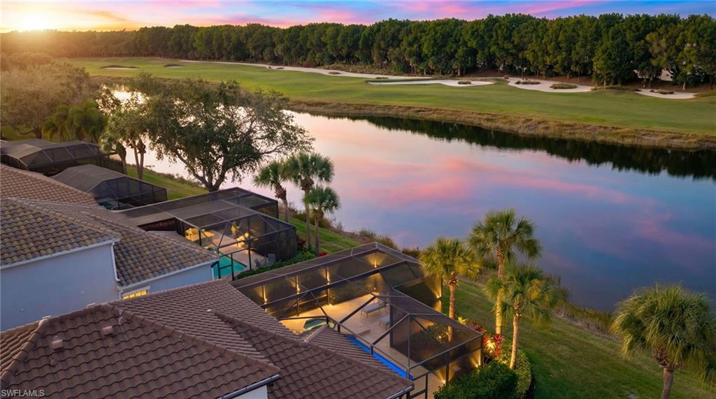 17959 Modena Road Miromar Lakes, FL 33913 - Photo 36 of 48 a view of a lake with a yard
