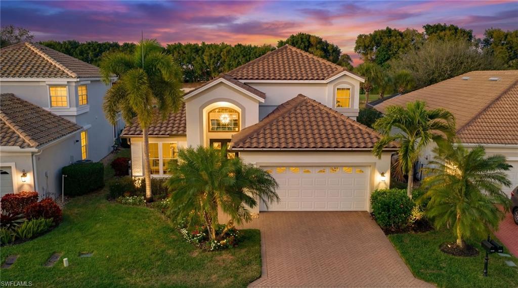 17959 Modena Road Miromar Lakes, FL 33913 - Photo 37 of 48 a front view of a house with a yard