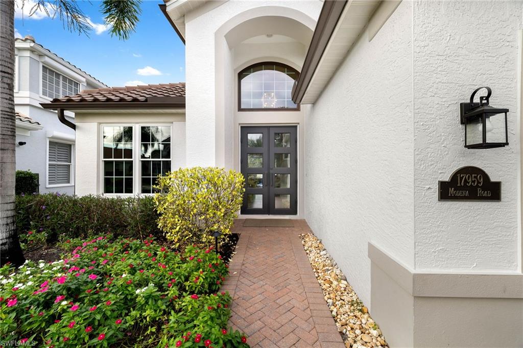 17959 Modena Road Miromar Lakes, FL 33913 - Photo 38 of 48 a front view of a house with garden
