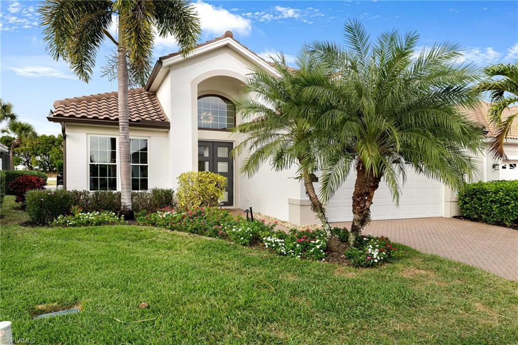 17959 Modena Road Miromar Lakes, FL 33913 - Photo 39 of 48 a front view of a house with a garden