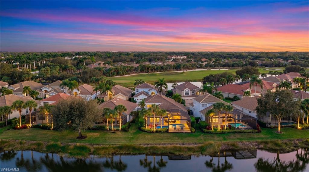 17959 Modena Road Miromar Lakes, FL 33913 - Photo 40 of 48 an aerial view of residential houses with outdoor space and trees