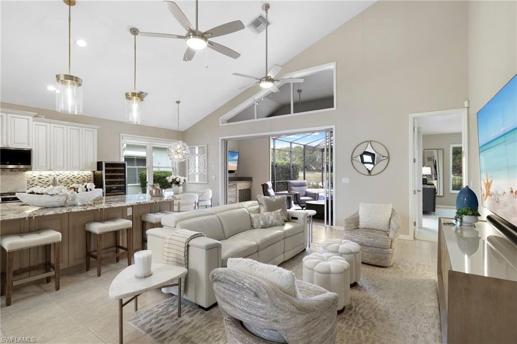 17959 Modena Road Miromar Lakes, FL 33913 - Photo 4 of 48 a living room with furniture kitchen view and a chandelier