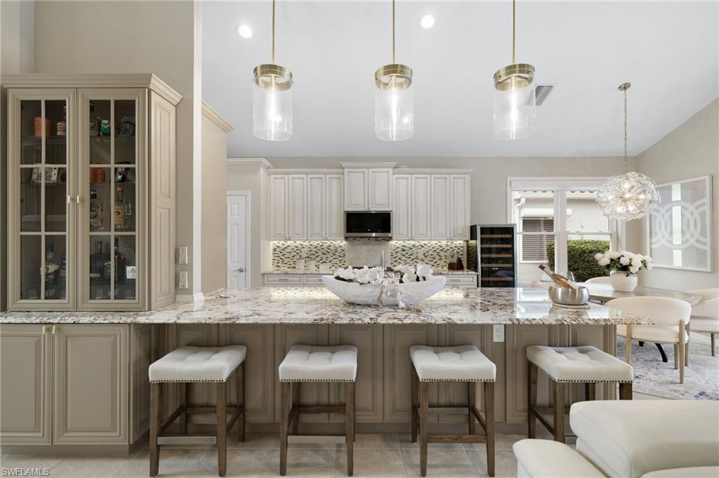 17959 Modena Road Miromar Lakes, FL 33913 - Photo 5 of 48 a kitchen with living room and chairs