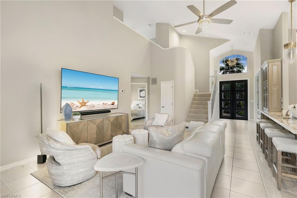 17959 Modena Road Miromar Lakes, FL 33913 - Photo 7 of 48 a living room with furniture and a fireplace