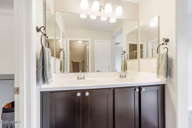 a bathroom with a double vanity sink and a mirror