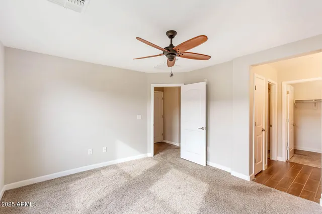 a view of a livingroom with a ceiling fan and window