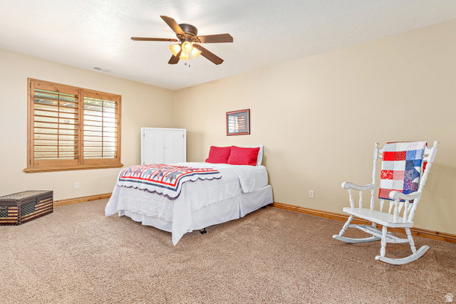 552 East Johns Way Sandy, UT 84070 - Photo 48 of 67 Carpeted flooring, wood-framed window with plantation shutters, ceiling fan with integrated lighting, neutral wall tones, and wood baseboards