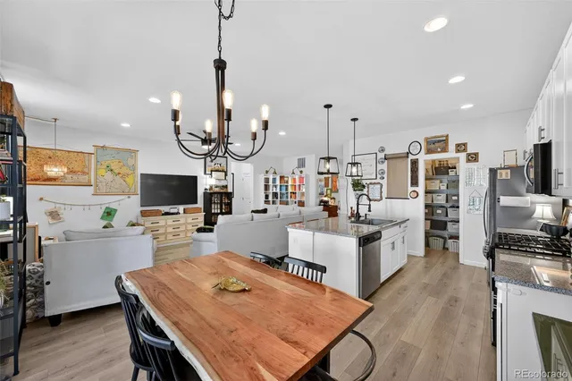 a living room with furniture a flat screen tv and kitchen view