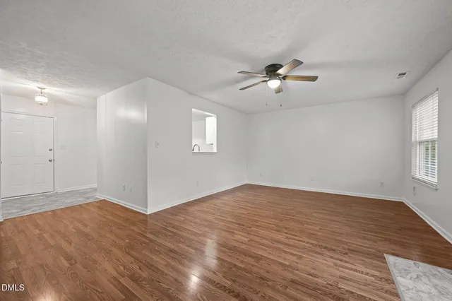wooden floor in an empty room with a window