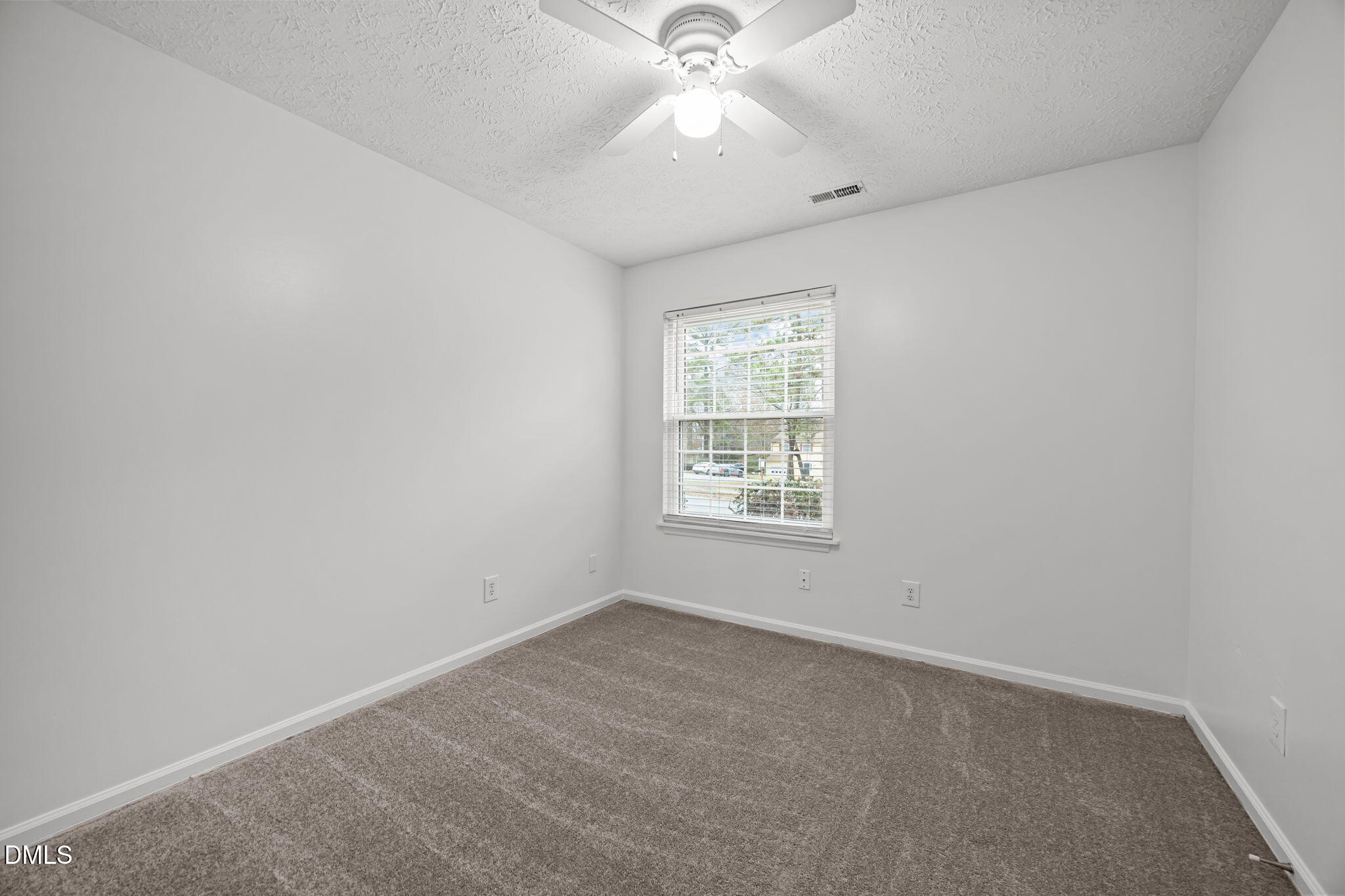 3333 Jo Anne Drive Raleigh, NC 27603 - Photo 12 of 24 an empty room with a window and a fan